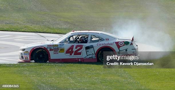 Kyle Larson, driver of the Cartwheel Chevrolet, celebrates with a burnout after winning the NASCAR Nationwide Series TREATMYCLOT.COM 300 at Auto Club...