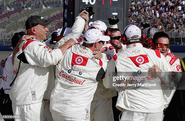 The crew of Kyle Larson, driver of the Cartwheel Chevrolet, celebrate after winning the NASCAR Nationwide Series TREATMYCLOT.COM 300 at Auto Club...