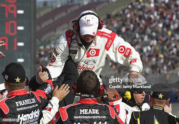 The crew of Kyle Larson, driver of the Cartwheel Chevrolet, celebrate after winning the NASCAR Nationwide Series TREATMYCLOT.COM 300 at Auto Club...