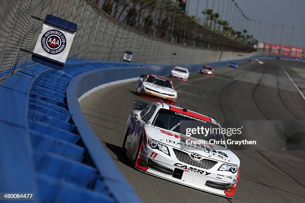 Elliott Sadler, driver of the GameStop-Turtle Beach Toyota, races during the NASCAR Nationwide Series TREATMYCLOT.COM 300 at Auto Club Speedway on...