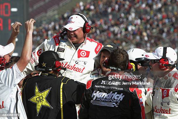 The crew of Kyle Larson, driver of the Cartwheel Chevrolet, celebrate after winning the NASCAR Nationwide Series TREATMYCLOT.COM 300 at Auto Club...