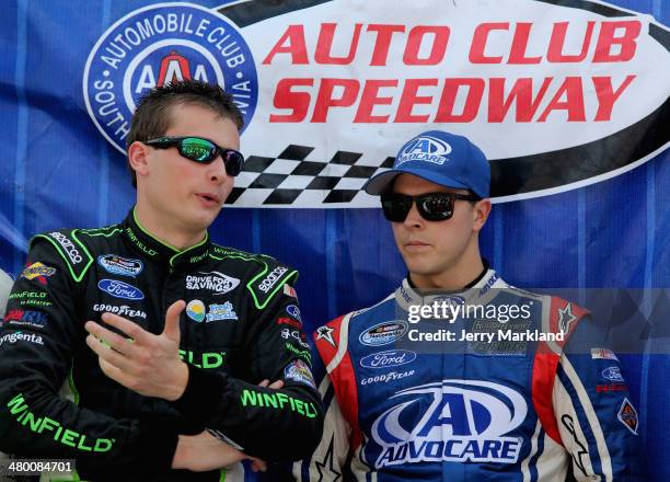 Dakoda Armstrong, driver of the Charter Ford, and Trevor Bayne, driver of the AdvoCare Ford, talk prior to the NASCAR Nationwide Series...