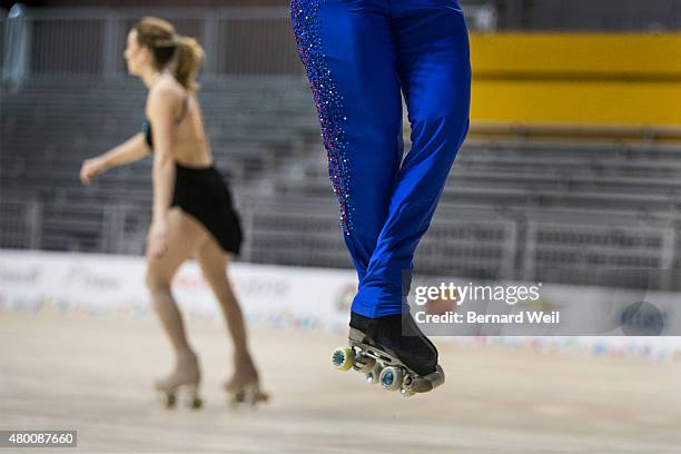 Mexican Roller figure skater Luis Reyna gets airborne as he practices his routine during a training session as Canadian Kailah Macri skates by, at...