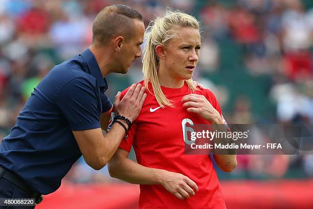 Mark Sampson coach of England talks with Laura Bassett during the FIFA Women's World Cup 2015 third place play-off match between Germany and England...