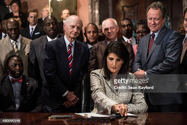 South Carolina Gov. Nikki Haley signs a bill to remove the Confederate battle flag from the state house grounds July 9, 2015 in Columbia, South...