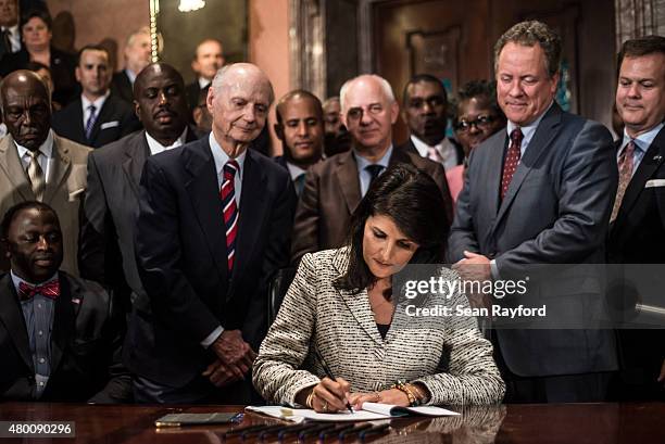 South Carolina Gov. Nikki Haley signs a bill to remove the Confederate battle flag from the state house grounds July 9, 2015 in Columbia, South...