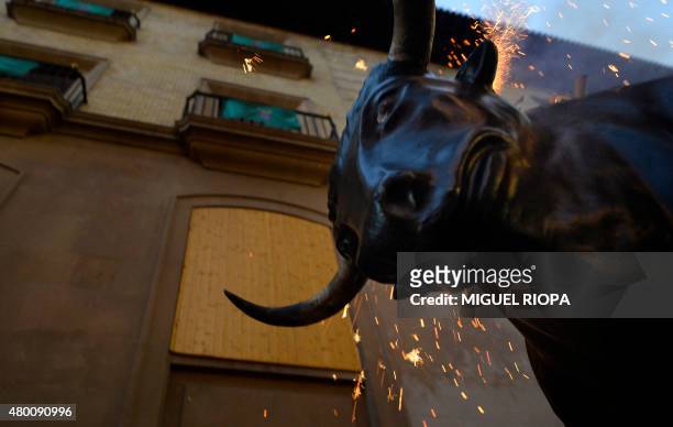 Toro de Fuego" throws sparks as it chases spectators during the San Fermin Festival, on July 9 in Pamplona, northern Spain. The festival is a symbol...