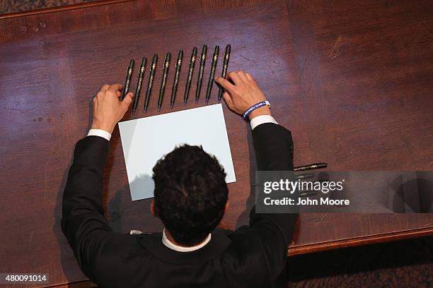 Staffer arranges pens ahead of a ceremony where Governor Nikki Haley was to sign a bill removing the Confederate flag from outside the statehouse on...