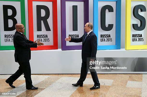 South African President Jacob Zuma greets Russian President Vladimir Putin during the BRICS 2015 Summit in Ufa, Russia, July 2015. Leaders of China,...