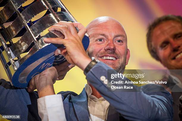 In this handout image provided by the Volvo Ocean Race, Abu Dhabi Ocean Racing Skipper Ian Walker holding the trophy of the winners of the Volvo...