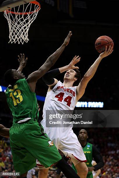 Frank Kaminsky of the Wisconsin Badgers shoots the ball against Richard Amardi of the Oregon Ducks during the third round of the 2014 NCAA Men's...