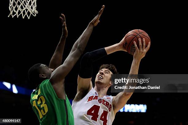 Frank Kaminsky of the Wisconsin Badgers shoots the ball against Richard Amardi of the Oregon Ducks during the third round of the 2014 NCAA Men's...