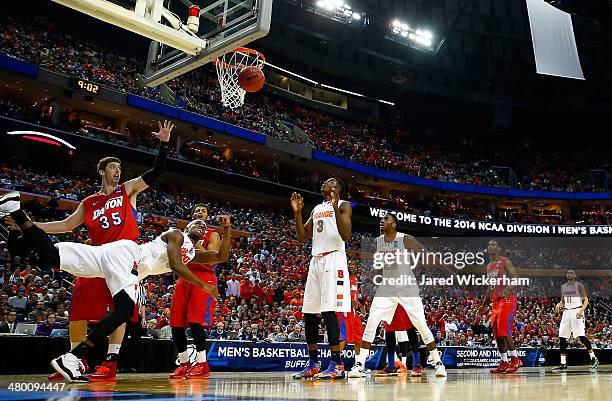 Fair of the Syracuse Orange goes to the basket as Matt Kavanaugh of the Dayton Flyers defends during the third round of the 2014 NCAA Men's...