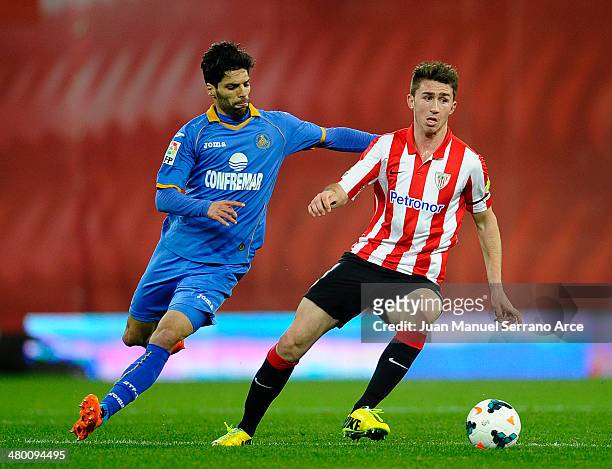 Aimeric Laporte of Athletic Club duels for the ball with Angel Lafita of Getafe CF during the La Liga match between Athletic Club and Getafe CF at...