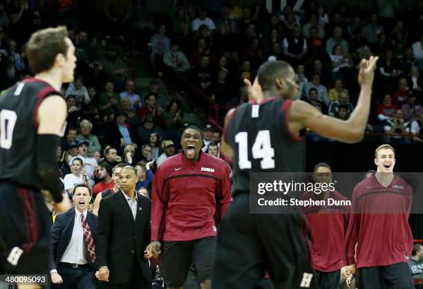 The Harvard Crimson celebrate as they tie the score in the second half against the Michigan State Spartans during the Third Round of the 2014 NCAA...