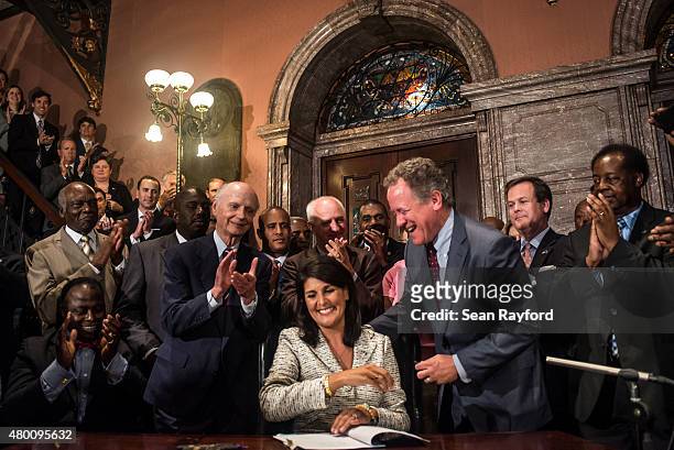 South Carolina Governor Nikki Haley signs a bill to remove the Confederate battle flag from the state house grounds July 9, 2015 in Columbia, South...