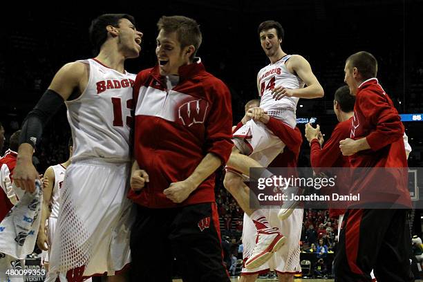 Frank Kaminsky of the Wisconsin Badgers celebrates with his team after defeating the Oregon Ducks during the third round of the 2014 NCAA Men's...