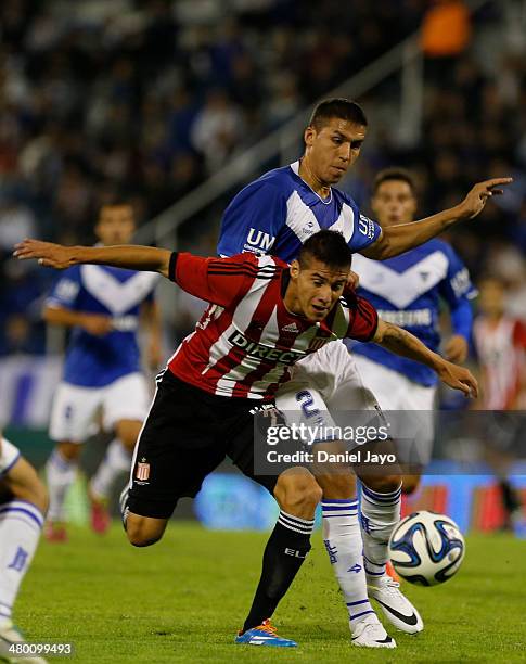 Carlos Auzqui, of Estudiantes, and Fernando Tobio, of Velez Sarsfield, fight for the ball during a match between Velez Sarsfield and Estudiantes as...