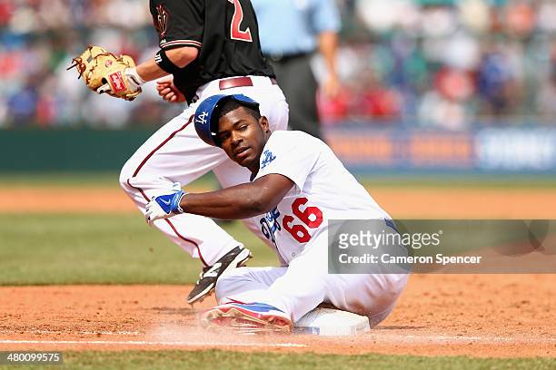 Yasiel Puig of the Dodgers is tagged out sliding back to first base during the MLB match between the Los Angeles Dodgers and the Arizona Diamondbacks...