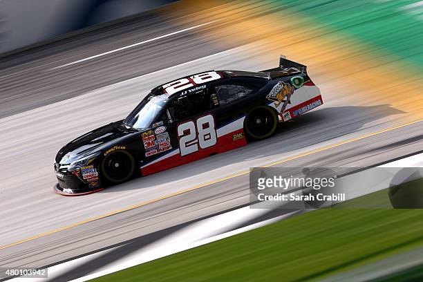 Yeley, driver of the Texas 28 Spirits Stage Toyota drives during the NASCAR Camping World Truck Series UNOH 225 at Kentucky Speedway on July 9, 2015...