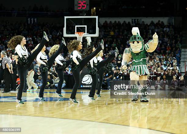 Michigan State Spartans mascot, Sparty, and cheerleaders perform in their game against the Harvard Crimson during the Third Round of the 2014 NCAA...