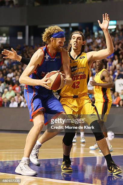 Luke Schenscher of the 36ers is blocked by Auryn MacMillan of the Tigers during the round 23 NBL match between the Adelaide 36ers and the Melbourne...