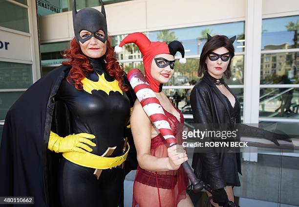 Attendees dressed as Batgirl, Harley Quinn and Catwoman pose on the first day of Comic Con International in San Diego, California, July 9, 2015. AFP...