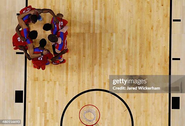 Members of the Dayton Flyers huddle together against the Syracuse Orangemen during the third round of the 2014 NCAA Men's Basketball Tournament at...