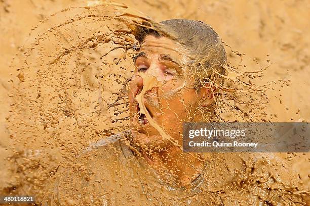 Competitor falls into muddy water during Toughmudder at Phillip Island Grand Prix Circuit on March 22, 2014 in Phillip Island, Australia.