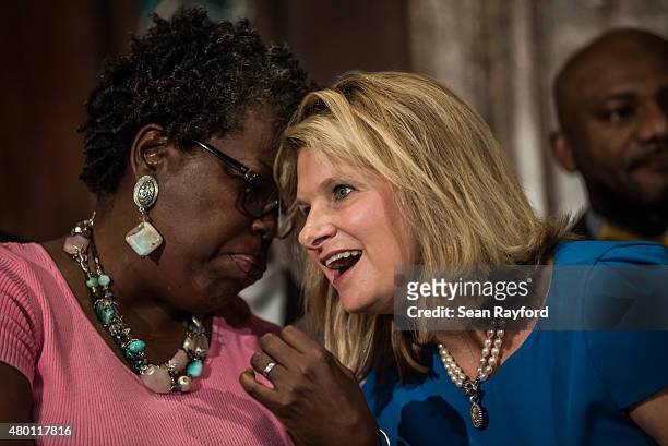 State Reps. Gilda Cobb-Hunter and Jenny Horn share a laugh at the state house July 9, 2015 in Columbia, South Carolina. Nikki Haley signed a bill...