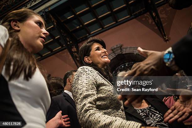 South Carolina Governor Nikki Haley receives hugs after signing a bill to remove the Confederate battle flag from the state house grounds July 9,...