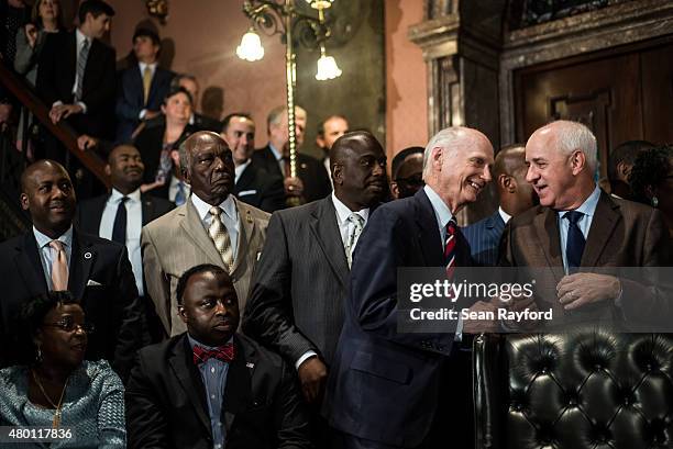 Former South Carolina Governor Jim Hodges talks with Charleston Mayor Joe Riley July 9, 2015 in Columbia, South Carolina. Governor Nikki Haley signed...