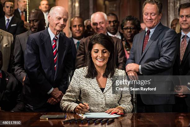 South Carolina Governor Nikki Haley receives applause after signing a bill to remove the Confederate battle flag from the state house grounds July 9,...