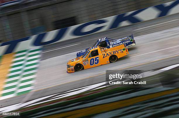 Tyler Reddick, driver of the BBR Music Group Toyota, and John Wes Townley, driver of the Zaxby's Chevrolet, race during the NASCAR Camping World...
