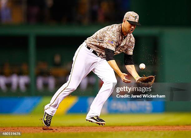 Jordy Mercer of the Pittsburgh Pirates bobbles a ground ball in the fifth inning against the St Louis Cardinals during the game at PNC Park on July...