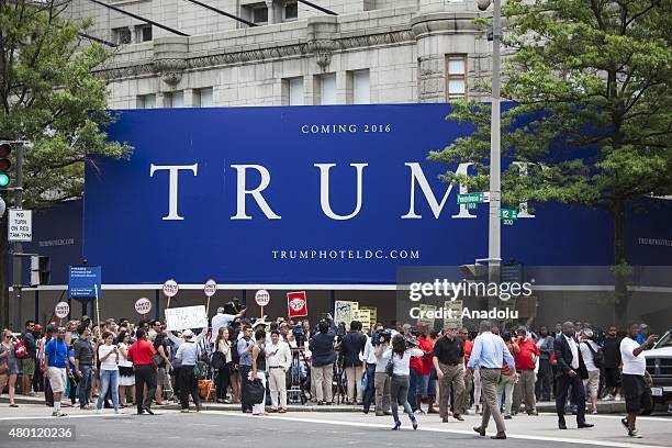 People gather in front of the under construction Trump Hotel to protest Donald Trump, candidate for the Republican Presidential ticket, after he made...