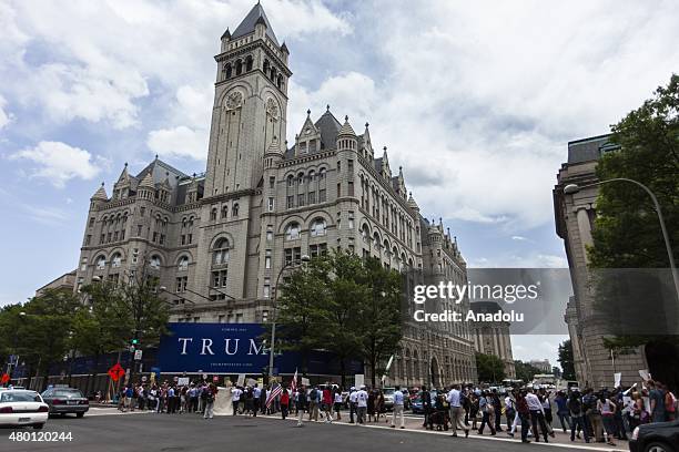 People gather in front of the under construction Trump Hotel to protest Donald Trump, candidate for the Republican Presidential ticket, after he made...