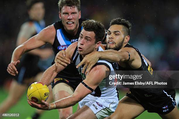 Jarryd Blair of the Magpies is tackled by Jarman Impey of the Power during the 2015 AFL round 15 match between Port Adelaide Power and the...