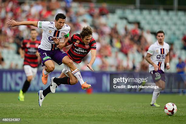 Jacob Burns of Perth and Mateo Poljak of the Wanderers contest the ball during the round 24 A-League match between the Western Sydney Wanderers and...