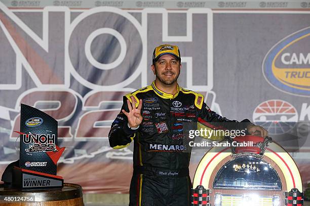 Matt Crafton, driver of the Ideal Door/Menards Toyota, celebrates after winning the NASCAR Camping World Truck Series UNOH 225 at Kentucky Speedway...