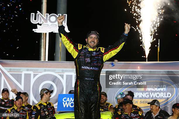 Matt Crafton, driver of the Ideal Door/Menards Toyota, celebrates after winning the NASCAR Camping World Truck Series UNOH 225 at Kentucky Speedway...