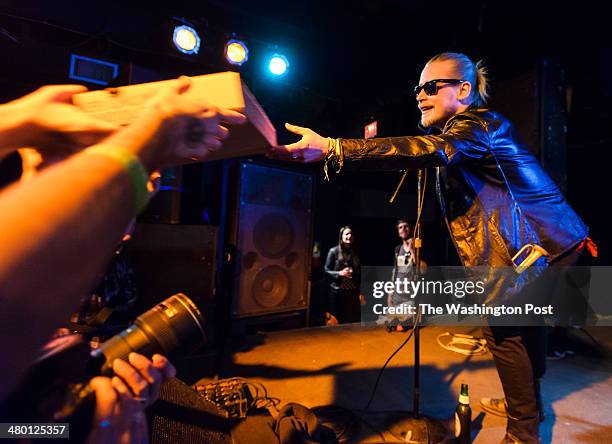 March 21st, 2014 - Macaulay Culkin of the Pizza Underground hands out pizza to fans at their performance at the Black Cat in Washington, D.C.