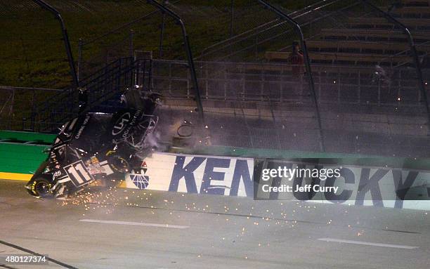 Ben Kennedy, driver of the Local Motors Toyota, crashes into the fence and wall during the NASCAR Camping World Truck Series UNOH 225 at Kentucky...