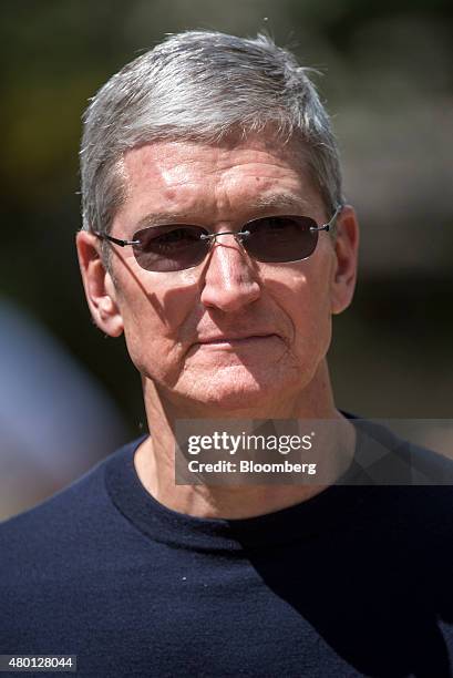 Tim Cook, chief executive officer of Apple Inc., walks the grounds after a morning session during the Allen & Co. Media and Technology Conference in...
