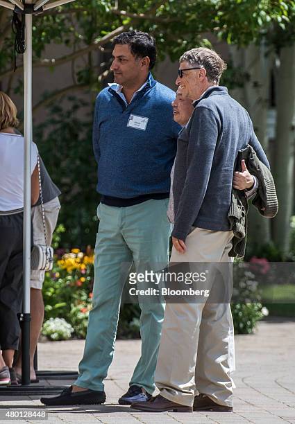 Bill Gates, chairman and founder of Microsoft Corp., right, Masayoshi Son, chairman and chief executive officer of SoftBank Group Corp., center, and...