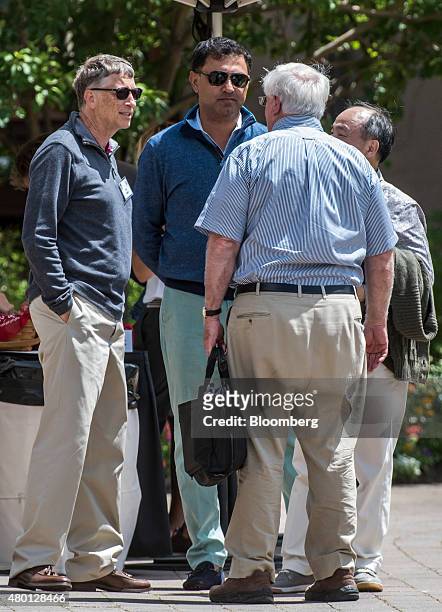 Bill Gates, chairman and founder of Microsoft Corp., left, Nikesh Arora, president of SoftBank Group Corp., center rear, and Masayoshi Son, chairman...
