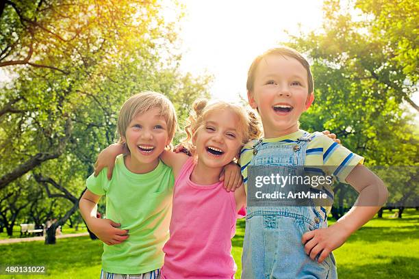 three happy children in summer - children only laughing stock pictures, royalty-free photos & images