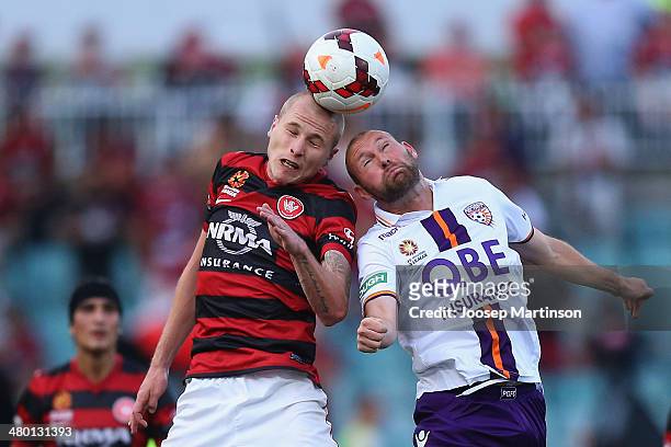 Aaron Mooy of the Wanderers competes for the ball with Steven McGarry of the Glory during the round 24 A-League match between the Western Sydney...