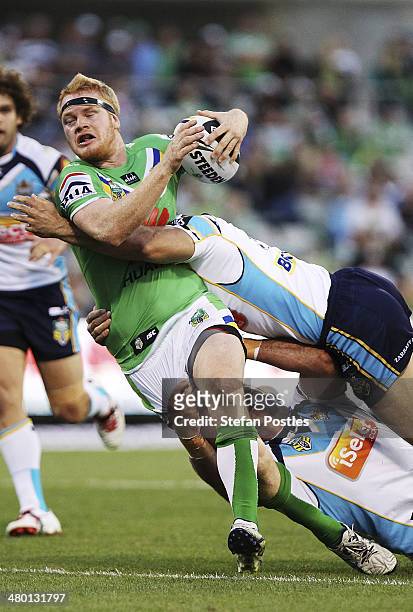 Joel Edwards of the Raiders is tackled during the round three NRL match between the Canberra Raiders and the Gold Coast Titans at GIO Stadium on...