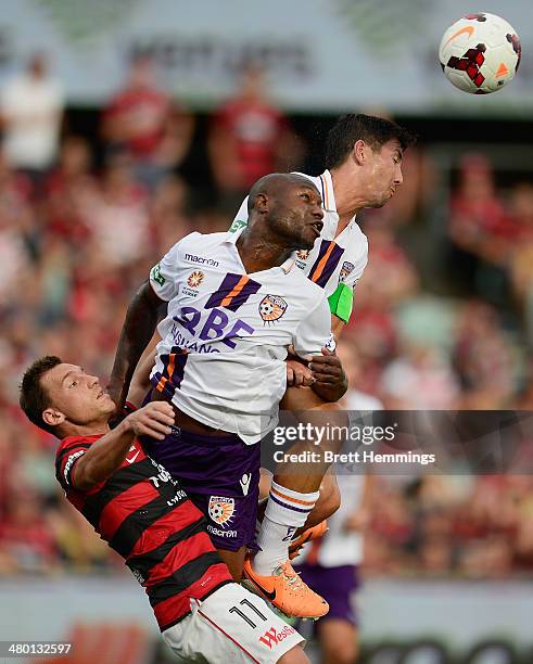 Brendon Santalab of the Wanderers, William Gallas and Jacob Burns of Perth contest a high ball during the round 24 A-League match between the Western...